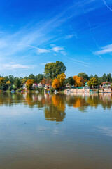 River Tisza and tiny houses at its riverbank in autumn. Beautiful seasonal landscape from Vojvodina, Serbia.