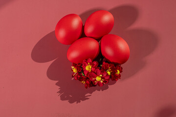 Colorful eggs, symbolizing Easter, on a colorful background and flowers