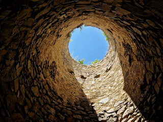 tourists at the old castle fell into the famine. the view from the well up to the light from heaven. the fortress from the Middle Ages needs to be repaired quickly before tourists are injured. search 