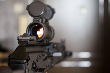 Assault rifle with collimator sight close up, selective focus. Modern weapon of military force