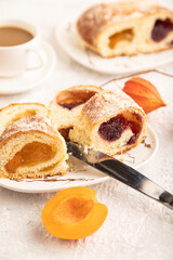 Homemade sweet bun with apricot jam on gray concrete. side view, selective focus.