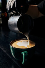 latte art, barista preparing cappuccino, pitcher with milk, cup with espresso, arabica, coffee