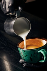 pitcher, pouring milk, barista in latex gloves preparing cappuccino, aromatic espresso, latte art