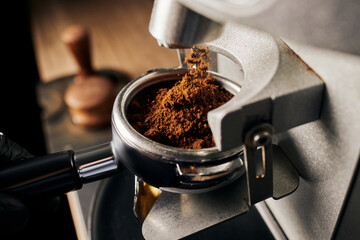 preparation of espresso, close up of grinded coffee in portafilter, coffee machine