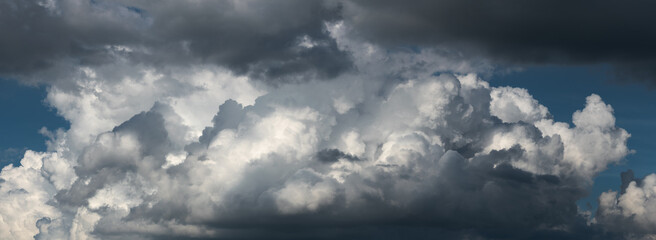 Contrasty scene of huge bright cloud against blue sky