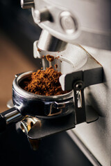 grinded coffee in portafilter, coffee machine, close up, coffee extraction, prepare of espresso