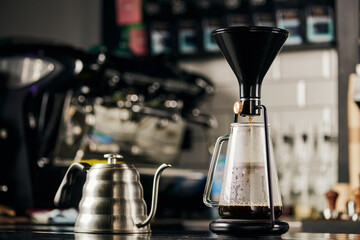 modern siphon coffee maker and metallic drip cattle for espresso preparation in modern cafe