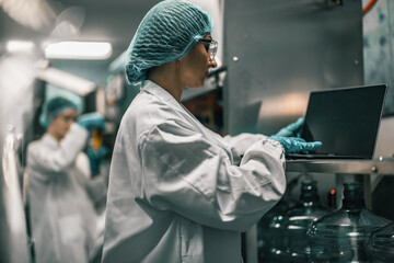 Water Quality Officer tests factory water with pH meter for safety, preventing contamination.