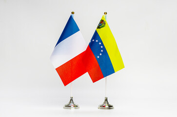 National flags of France and Venezuela on a light background.