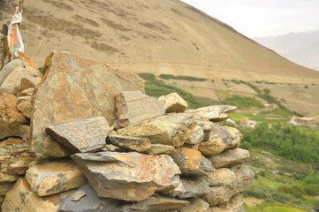 Buddhist mantra and statue carved on stones in Ladakh, INDIA 