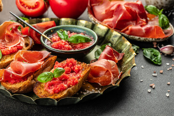 tomato toast with oil, jamon and tomato, traditional Spanish breakfast or lunch. Concept healthy...