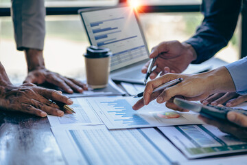 The fund manager team consults and discusses stock market analysis by meeting digital tablet business consultants to analyze and discuss the financial report situation in the conference room © ArLawKa