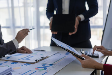 The fund manager team consults and discusses stock market analysis by meeting digital tablet business consultants to analyze and discuss the financial report situation in the conference room