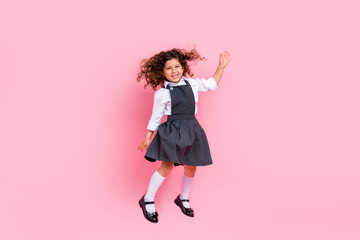 Full size photo of overjoyed carefree schoolchild jumping flying wear uniform isolated on pink...