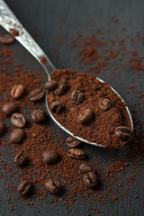 Coffee beans and ground coffee on a black background