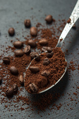 Coffee beans and ground coffee on a black background