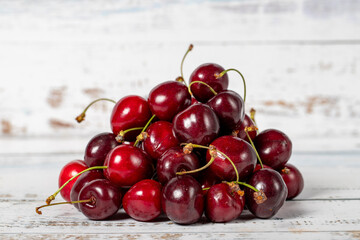 Cherry on a white wood background. Fresh cherry harvest season concept. Healthy and fresh fruit