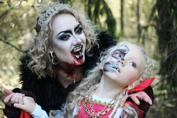 A woman in the form of a vampire or a sorceress bites a princess girl in fairy-tale makeup and...