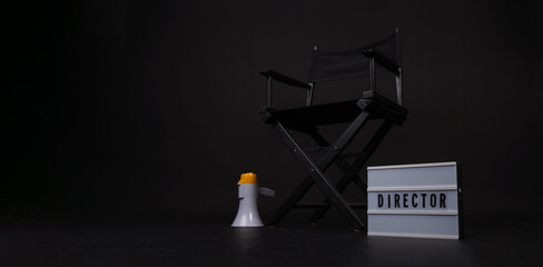 Fototapeta na wymiar Black director chair and clapper board and light box and on black background.