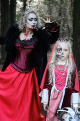 A woman in the form of a vampire or a sorceress is about to bite a princess girl in fairy-tale...