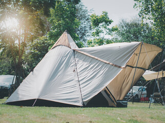 Campground Outdoor tent camping picnic on mountain with Equipment, Natural Camping area landscape background, with trees and green grass, summer trip relax and holiday Adventure Travel concept