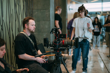 Director of photography with a camera in his hands on the set. Professional videographer at work on filming a movie