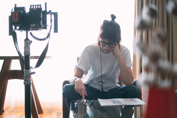 The director is a woman at work on the set. The director works with a group or with a playback...