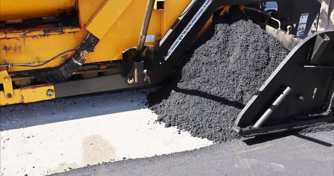 During highway construction work an asphalt paver machine steam road roller are used in order to layer new road