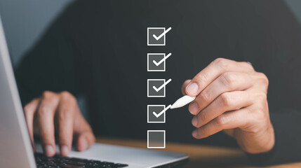 Businessman use pen to tick correct sign mark in checkbox for quality document control checklist...
