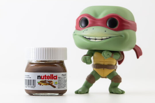 Funko POP vinyl figure of Rafael ninja turtle and mini Nutella sweetened hazelnut cocoa spread isolated on white background