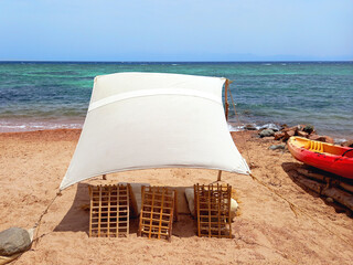 Rustic Berber chill out on the Red Sea coast in the Sinai Peninsula. Rustic canvas on the beach of...