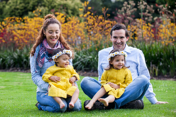 Fototapeta premium Family of four having fun outdoors in a beautiful sunny day at the park. Happiness concept. Family concept.