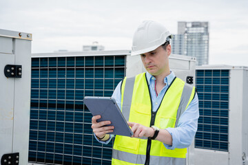 A team of engineers is checking the air conditioning cooling system of a major building or...