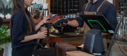 Woman use smartphone to scan QR code for order menu in cafe restaurant with a digital delivery....