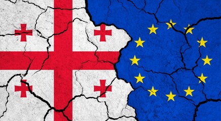 Flags of Georgia and European Union on cracked surface - politics, relationship concept