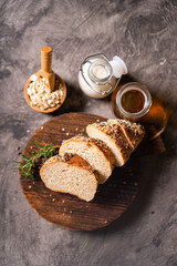 Artisan bread whole wheat baguette white milk and honey on rustic wooden board and abstract table. Sourdough bread
