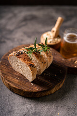 Artisan bread whole wheat baguette white milk and honey on rustic wooden board and abstract table. Sourdough bread

