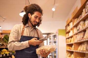 Ethnic seller scanning code food in grocery store