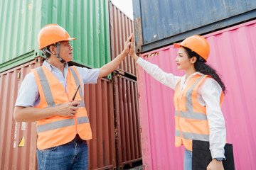 Team of logistics engineers, men and women in reflective jackets stand outside large commercial port. Containers in Export-Import Business and Logistics
