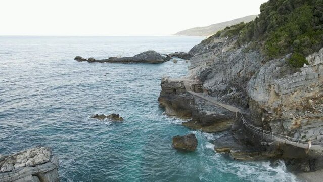 Drone 4k view of a cliff with stairs leading to the beach Mylopotamos Greece