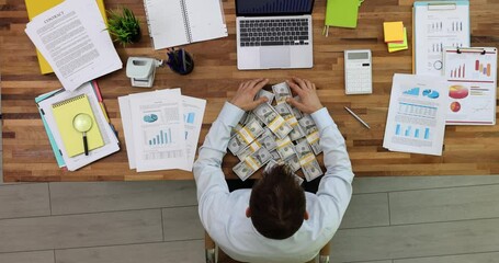 Seo worker holding money many stacks of money dollars top view. Businessman analyzing economic indicators, reports and charts at workplace
