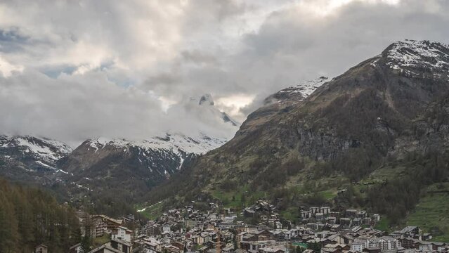 Zermatt Switzerland time lapse 4K, city skyline day to night timelapse at Zermatt city Valley and famous Matterhorn mountain peak