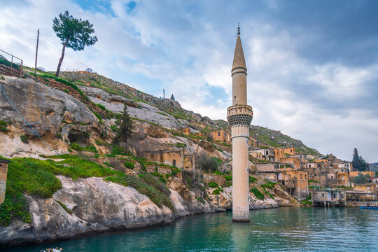 Halfeti village and its submerged minaret and Turkish flags of toursit boats
