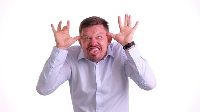 Young handsome man over isolated background making crazy and funny gesture. Funny facial expression and grimaces