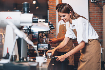 Professional Female Barista Making Hot Coffee with Coffee Machine in Cafe, Small Business Owner Working in Bar and Restaurant.