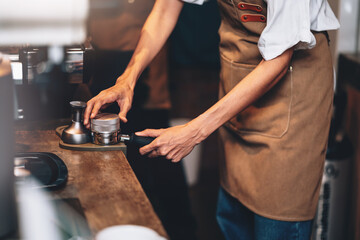 Professional Female Barista Preparing Coffee Powder For Brewing to Make Espresso Shot in Cafe. Small Business Entrepreneur Making Coffee in Her Shop.