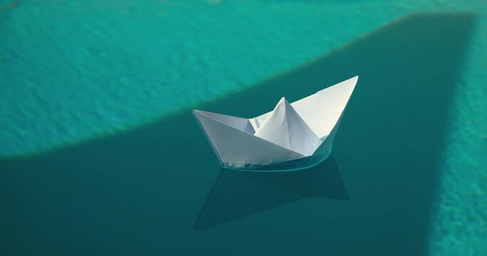 Delicate paper boat gently floating on crystal-clear waters. Get inspired by graceful simplicity of paper boat, and let your imagination set sail with this video. Tranquility and nostalgia concept