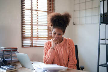 Young afro african american millennial entrepreneur working with financial documents..