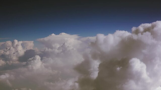 Beautiful blue sky background with clouds seen from commercial plane pilot cabin