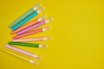 Many colorful markers on a colored background, flat lay. School stationery. The concept of study, office and drawing